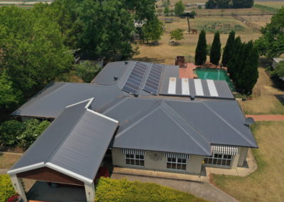 An aerial view of a Residential Metal Roofing with a swimming pool.